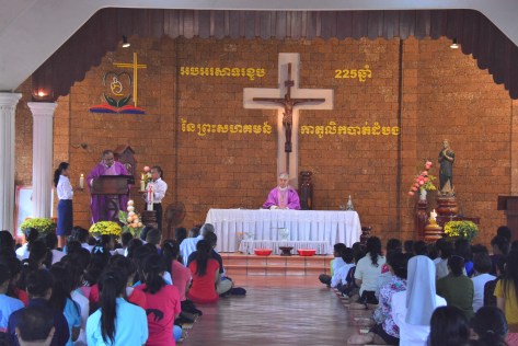 Father Totet proclaiming the Holy Gospel